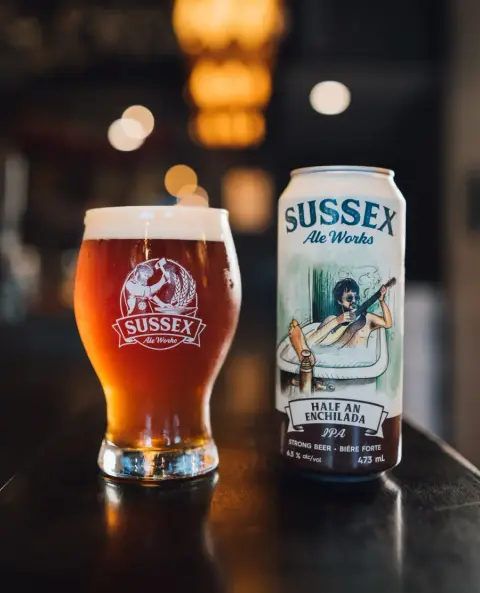 Half an Enchilada IPA in a glass beside its can