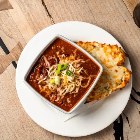 Chili topped with cheese and scallions.