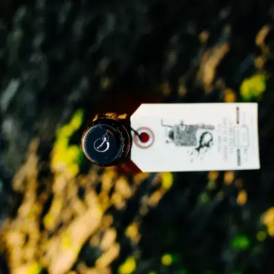 A 500 ml bottle of Tête d'Allumette craft beer on a table at the brewery