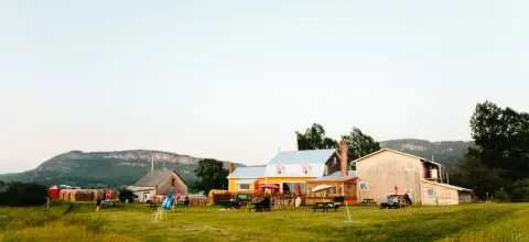 The yellow ancestral farmhouse and terrace of Tête d'Allumette at sunset