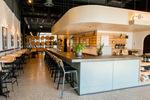 The Establishment taproom bar with barrels along the wall