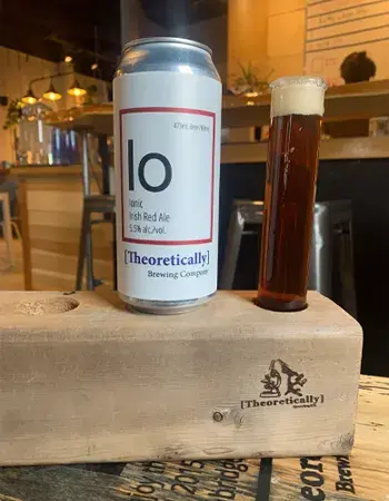 A can of Theoretically Brewing Ionic Irish Red Ale beside a filled glass
