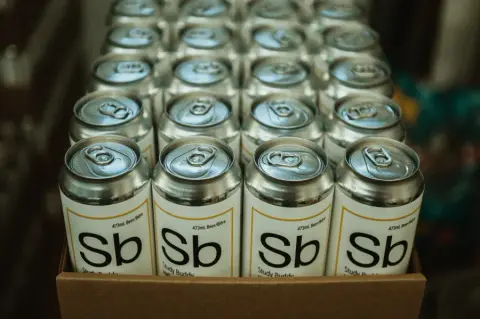 A tray of freshly canned Theoretically Brewing beer