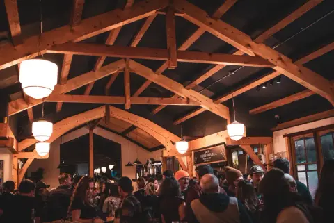 Ucluelet Brewing tasting room under the timber roof of the former St. Aidan's church