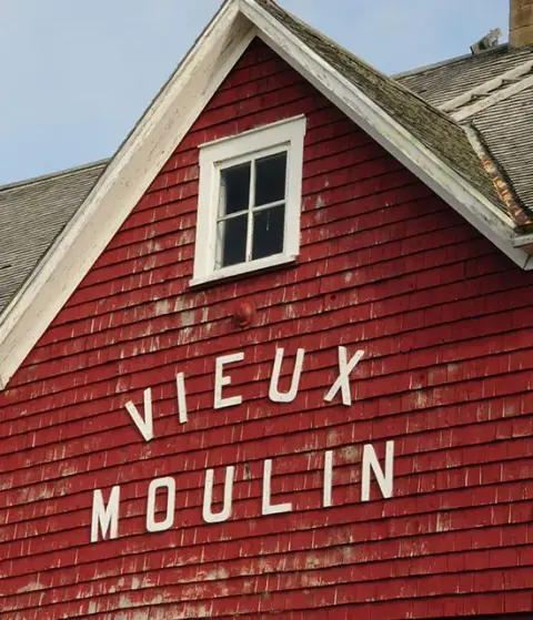The red-shingled Vieux Moulin building in Sainte-Flavie