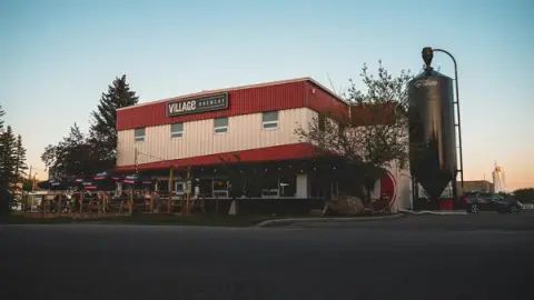 Village Brewery building in southeast Calgary at sunset