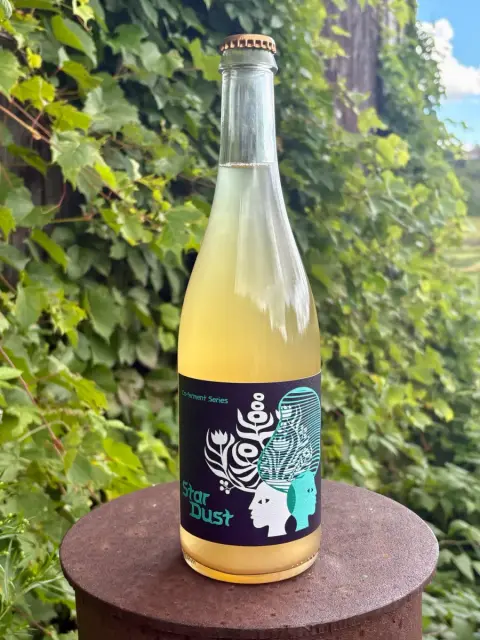 A bottle of Woodfolk Star Dust co-ferment cider